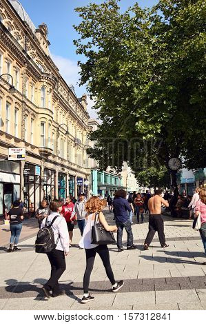 Cardiff, Wales, UK, September 14, 2016 :  People walking in the pedestrian precinct of Queen Street in the city centre