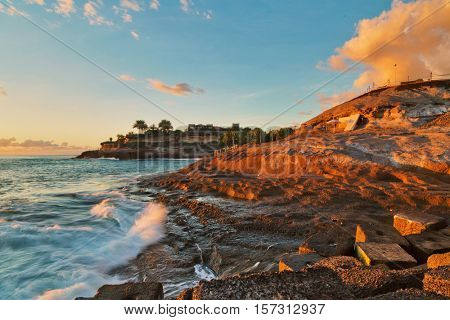 Rocks at topical beach at beautiful sunset.Costa Adeje, Tenerife, Spain