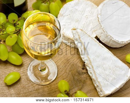 White wine brie caembert and grape on the wood surface
