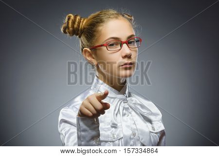 Closeup Thoughtful or contemptuous girl show at camera isolated on Gray.