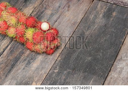 rambutan sweet fruit fresh on wood background :Select focus with shallow depth of field.
