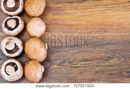Fresh Brown Mushrooms on Woody Background Studio Photo