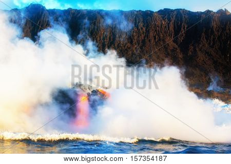 Smoke billows from ocean as molten lava flows into the water