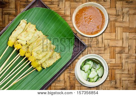 Grilled Pork Satay With Peanut Sauce And Vinegar On Woven Bamboo Background, Thai Food.