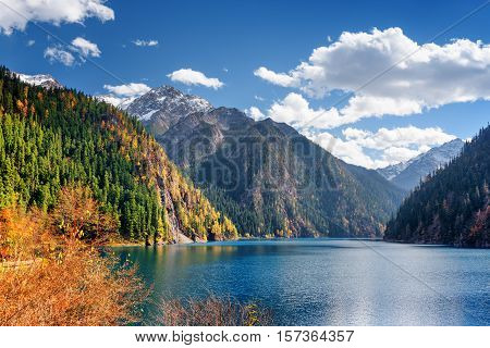 Beautiful View Of The Long Lake Among Fall Woods And Mountains