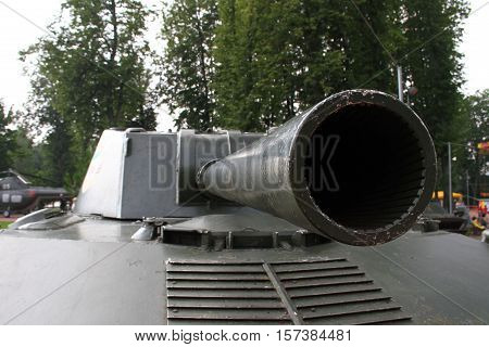Aimed gun barrel. Detail of military weapons.