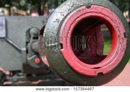 Aimed gun barrel. Detail of military weapons.