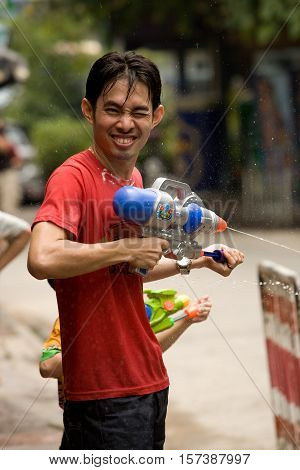 Bangkok, Thailand - April 13, 2008 : 
During Songkran the Thai New Year's festival. A young man with a water gun.