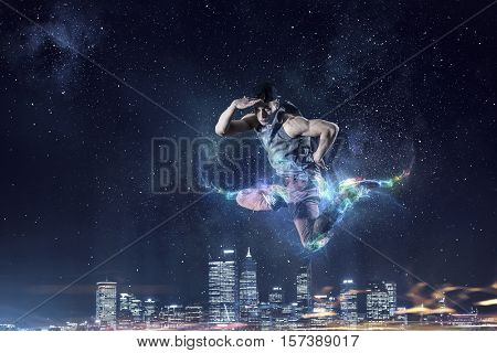 B-boy performing some moves . Mixed media