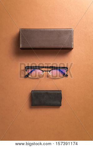 Brown eyeglasses eyewear frame and fabric over brown background top over head