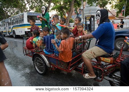 Bangkok, Thailand - April 13, 2008 : 
During Songkran the Thai New Year's festival. Teenagers watering passers-by on the street.