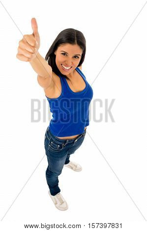 portrait of young beautiful latin woman giving thumb up happy and excited wearing jeans and top smiling cheerful isolated on white background