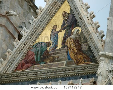 Siena - Duomo facade.The smaller mosaicPresentation of Mary in the Temple by Alessandro Franchi.