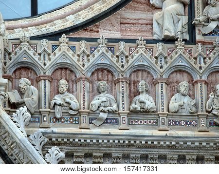 Architectural details of Duomo facade - SienaTuscanyItaly. The Duomo of Siena which was built in the 12th and 13th centuries is one of the prettiest churches in Gothic style in Italy