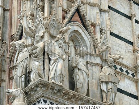 Architectural details of Duomo facade - SienaTuscanyItaly. The Duomo of Siena which was built in the 12th and 13th centuries is one of the prettiest churches in Gothic style in Italy