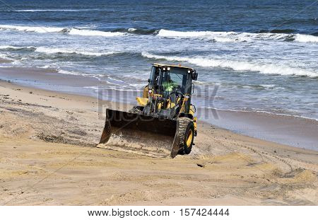 VILANO BEACH, FLORIDA, USA - OCTOBER 19, 2016: Heavy construction equipment clearing beach debris caused by hurricane Matthew hitting the east coast of Florida on October 7. 2016.