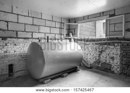 in a separate room in a old building there is a heating oil tank