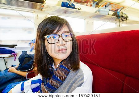 Young Asian Woman Traveling Looking Out The Window.