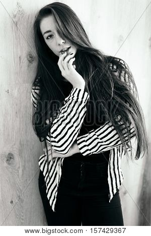 High fashion. Emotional portrait of a beautiful sexy brunette with long hair and bright make-up