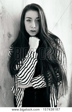 High fashion. Emotional portrait of a beautiful sexy brunette with long hair and bright make-up