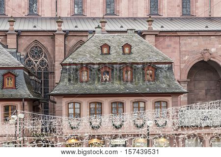 Man Watches The Szene Of The Christmas Market From An Old House
