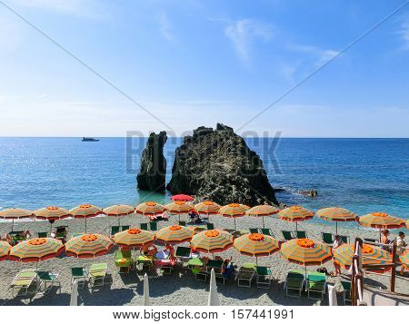 Monterosso, Italy - People on the coastline of Monterosso in Italy. Monterosso is one of five famous coastline villages in the Cinque Terre National Park.