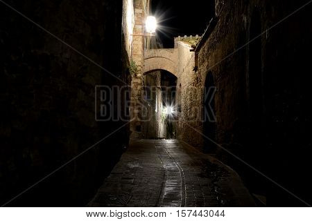 Narrow passage at night in San Gimignano in Tuscany Italy