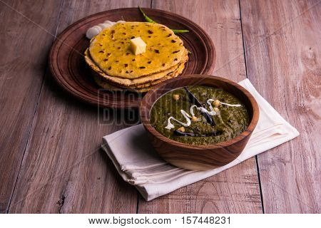 corn flour flat bread or roti or Makki Ki Roti with sarso da Saag or mustard leaves curry, Indian Food popular in winter season in north india