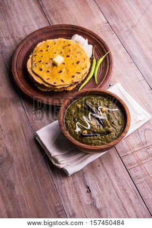 corn flour flat bread or roti or Makki Ki Roti with sarso da Saag or mustard leaves curry, Indian Food popular in winter season in north india