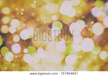 background with natural bokeh defocused sparkling lights. Colorful metallic texture with twinkling lights. Bright and vivid colors