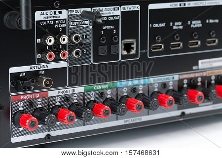 Closeup of the back of an AV receiver showing the speaker terminals component connectors. Audio receiver isolate on a white background studio