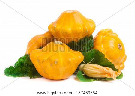four yellow pattypan squash with leaf and flower isolated on white background.