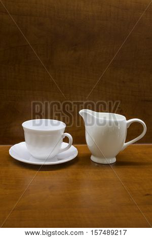Porcelan cup on the brown table, background