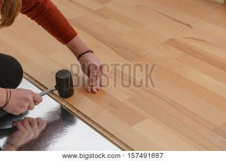 Worker laying a parquet floor - close-up of craftwork