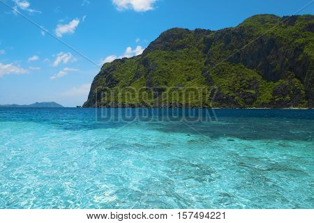 Beautiful tropical sea bay. Scenic landscape with blue lagoon and mountain island El Nido Palawan Philippines Southeast Asia. Exotic scenery. Popular landmark tourist destination of Philippines