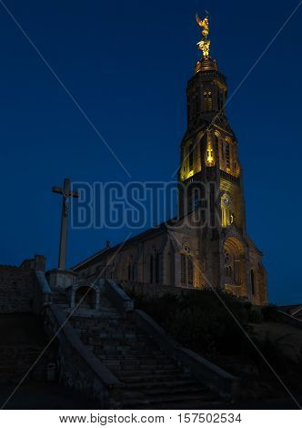 Church of Saint Michael in Saint-Michel-Mont-Mercure France with a large figure of the Archangel Michael at the top of the tower