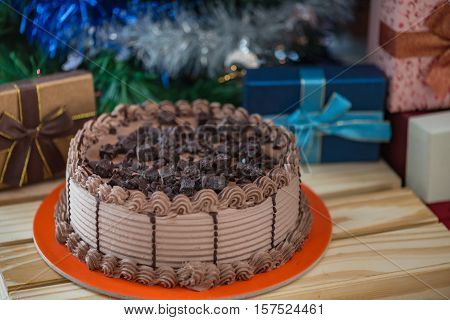Close up of chocolate cake with fresh cream topping with chocolate chunk and dark chocolate ice cream inside.
