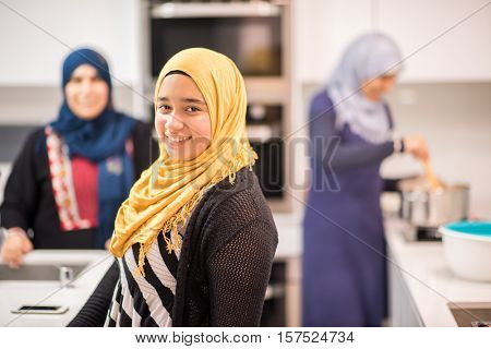 Group of Muslim women in kitchen making food