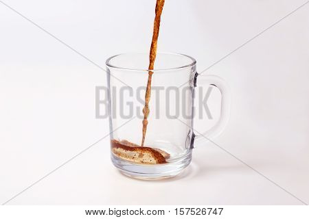 black coffee is poured in a transparent mug on a white background