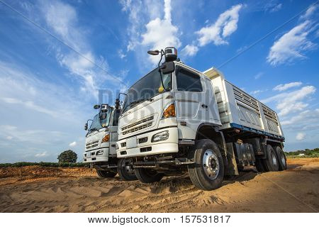 Construction Site Digger, Excavator And Dumper Truck. Industrial Machinery On Building Site.