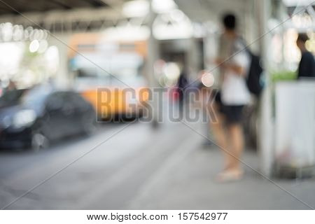 Blurry Out of Focus Image of People Waiting at a Bus Stop