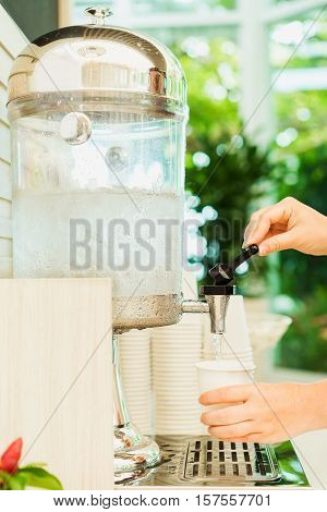 Coupling girl pours fresh water into the paper cup. Drinking water.