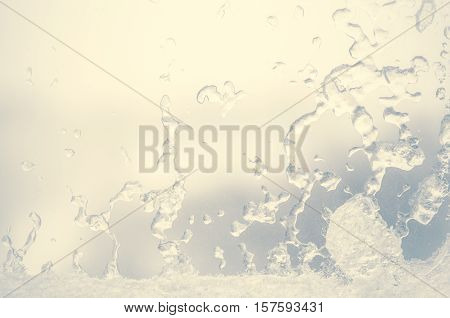 Ice water drops on winter glass. Frost patterns on window. Frosty natural pattern on winter window. Ice on a window background texture. Light blue frozen window glass background.