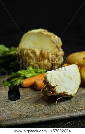 Ingredients for celeriac soup - celery root - celeriac carrots onion potatoes - healthy diet concept