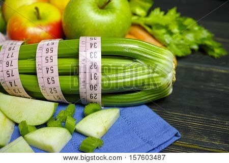 Green vegetables and fruits - celery shoots and apples healthy fitness diet concept