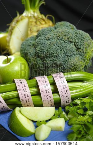 Green vegetables and fruits - celeriac broccoli celery shoots and apples healthy fitness diet concept