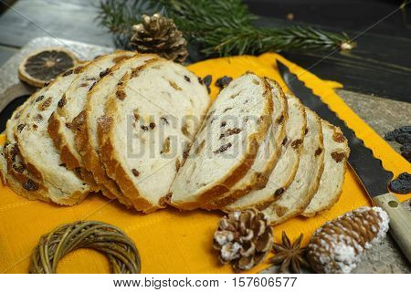 Fresh baked raisins bread sliced on granite board holiday concept