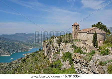 The Antique Church Is Extant In The Old Small Village On The Abrupt Cliff In The Prades Mountains.