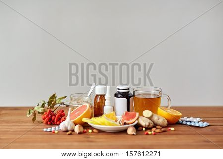 health, traditional medicine and ethnoscience concept - natural and synthetic drugs on wooden table