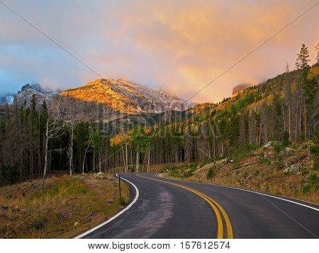 The peaks light up at sunrise along Bear Lake Road in Rocky Mountain National Park.